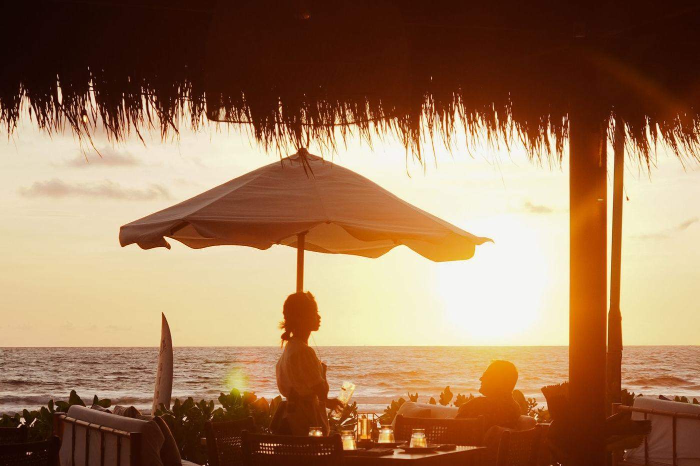 A beachside restaurant at sunset.